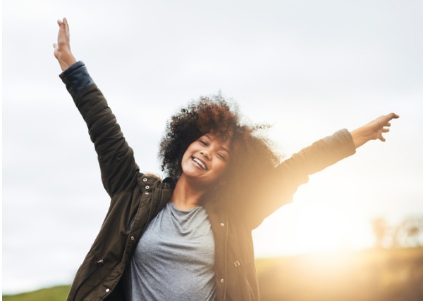 woman embraces abundance in her life with joy