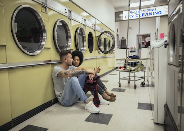 woman talks to her boyfriend in a laundromat about the personal transformation she's been experiencing