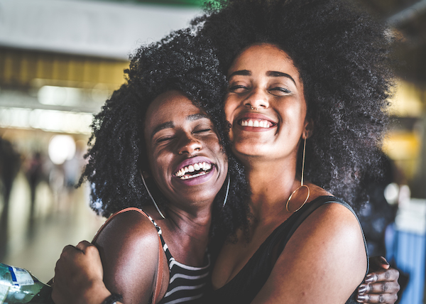 women practicing gratitude for each other