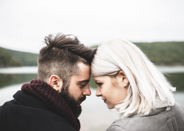 a young couple bows to each other to communicate appreciation for their love