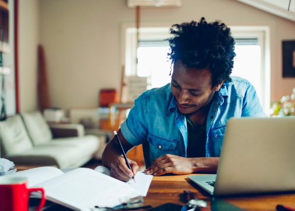 man focusing on his new years intentions in his home office